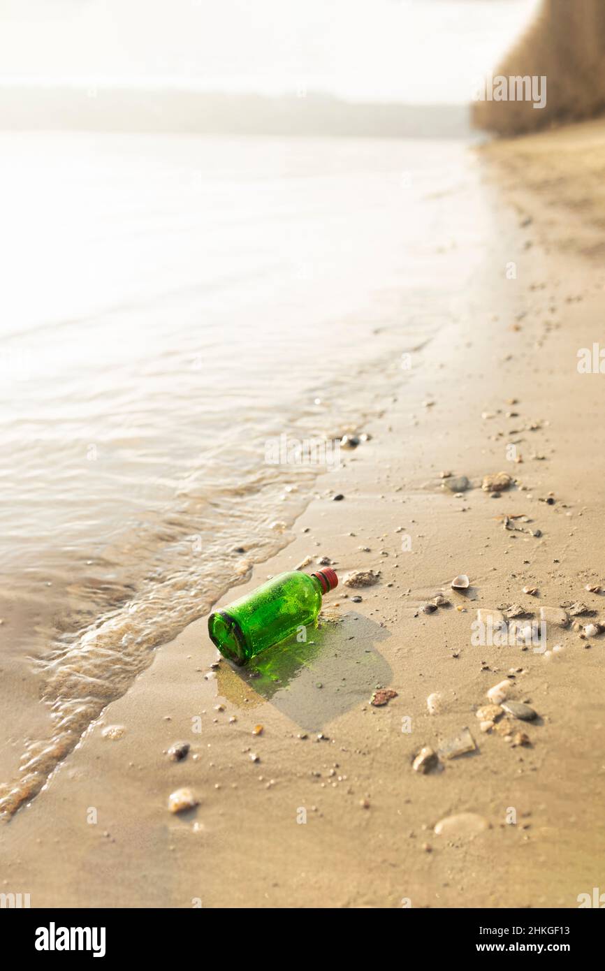 Glass waste laying around on the shore Stock Photo