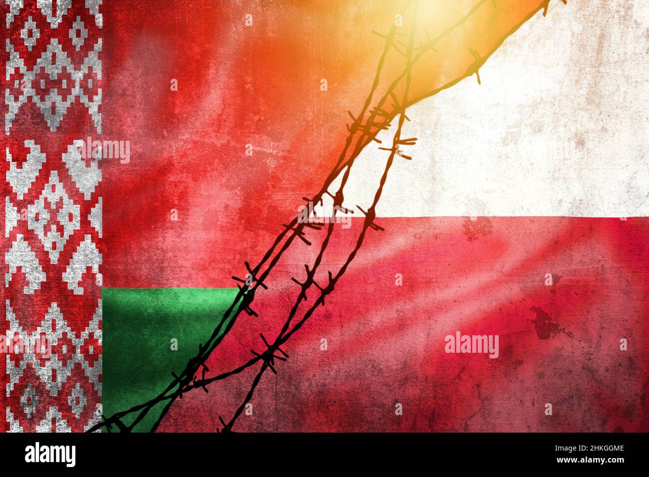 Grunge flags of Belarus and Poland divided by barb wire and sun haze illustration, concept of tense relations in migrant border crisis Stock Photo