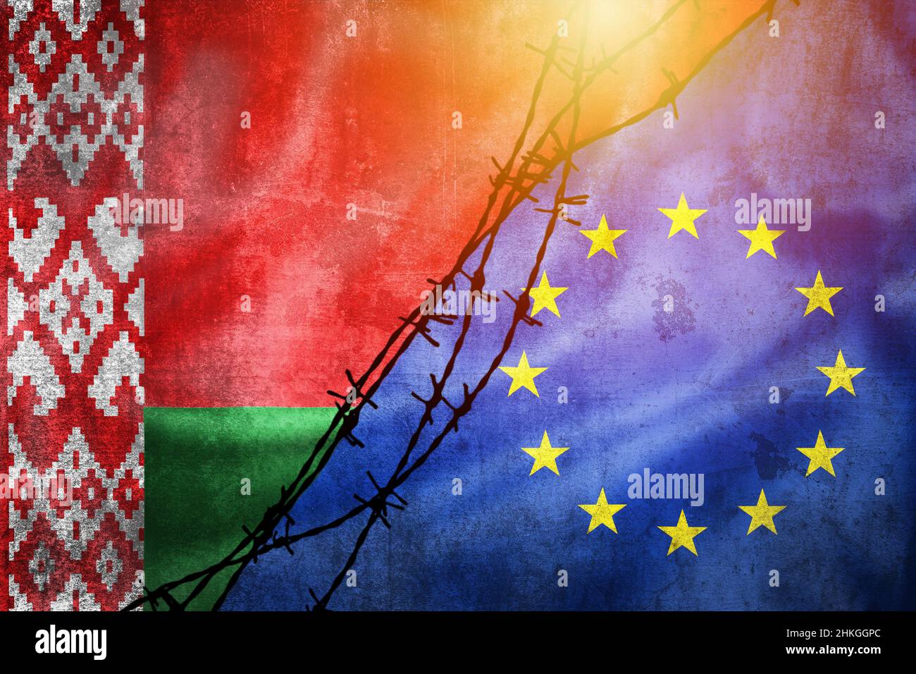 Grunge flags of Belarus and European Union divided by barb wire with sun haze illustration, concept of tense relations in migrant border crisis Stock Photo