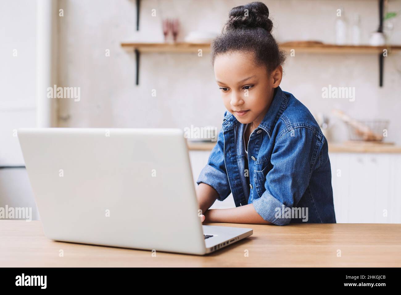 Cute little girl using laptop at home. Education, online learning, home ...