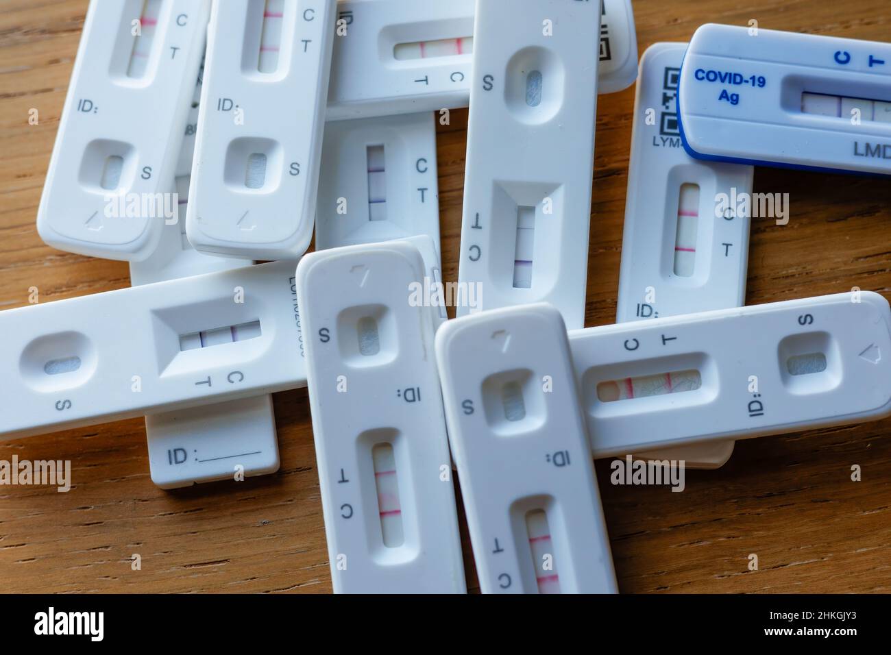 Pile of positive Covid-19 rapid home lateral flow antigen tests Stock Photo