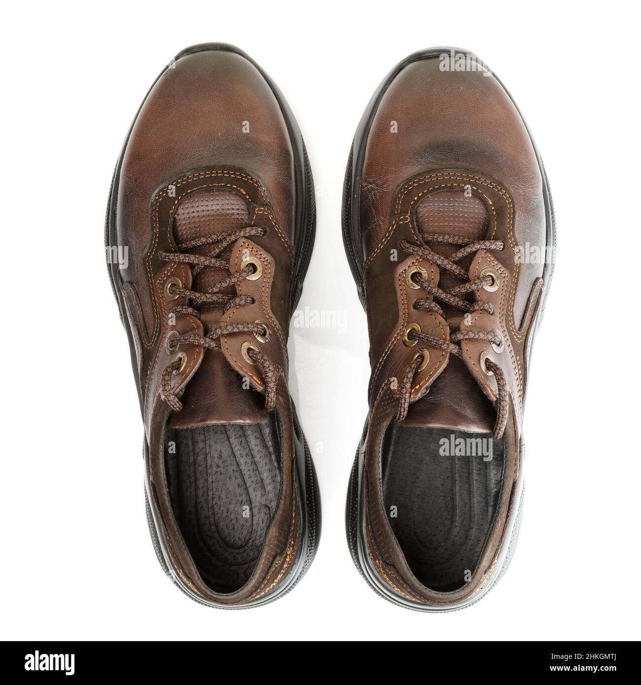 Pair of brown leather walking shoes on white background shot from above Stock Photo