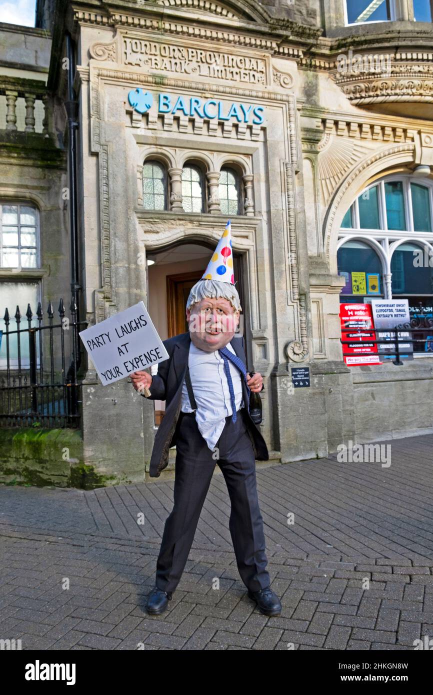 Boris Johnson clown puppet caricature wearing mask outside in Carmarthen  street Extinction Rebellion protest v Barclays Bank 4th 4 February 2022 UK Stock Photo