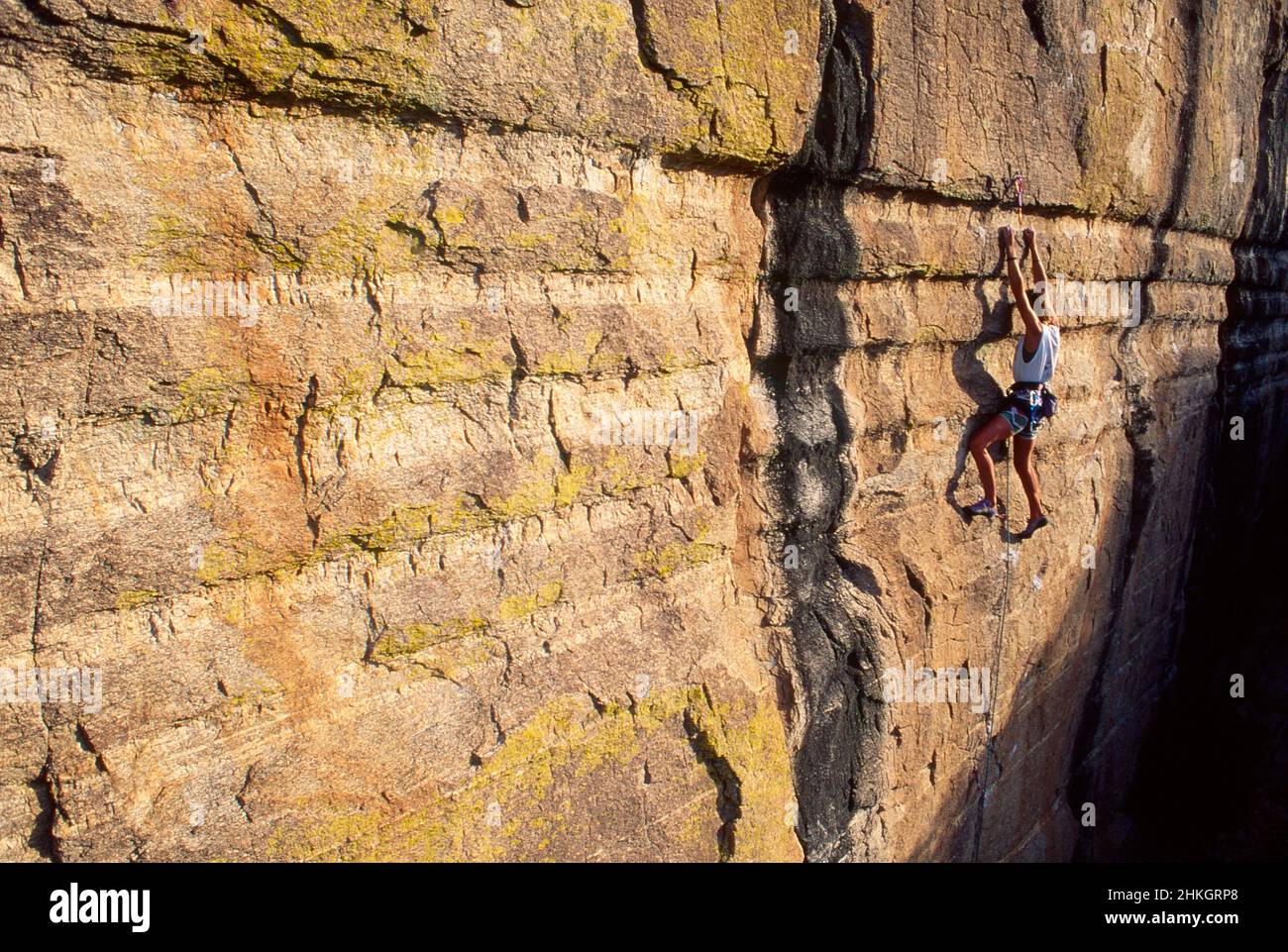 Female rock climber climbing a difficult route at Windy Point. Santa