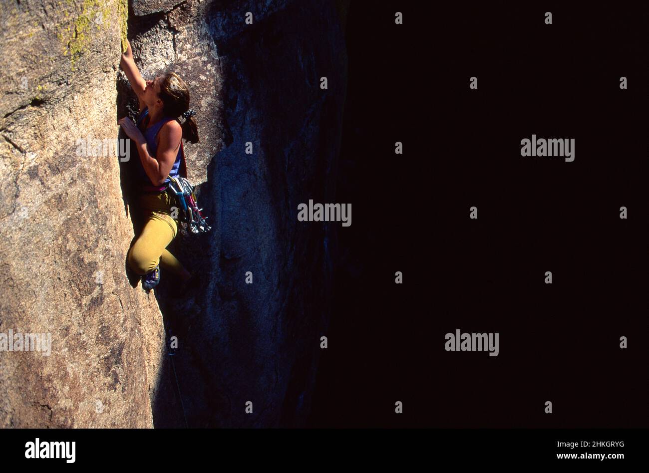 Female rock climber climbing a difficult route at Windy Point. Santa