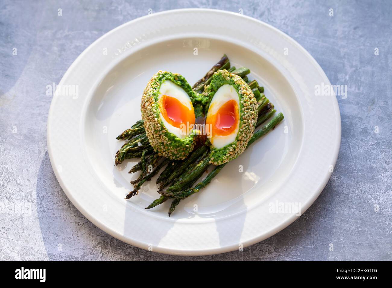 Vegetarian Scotch egg wrapped in pea and broad bean mash Stock Photo