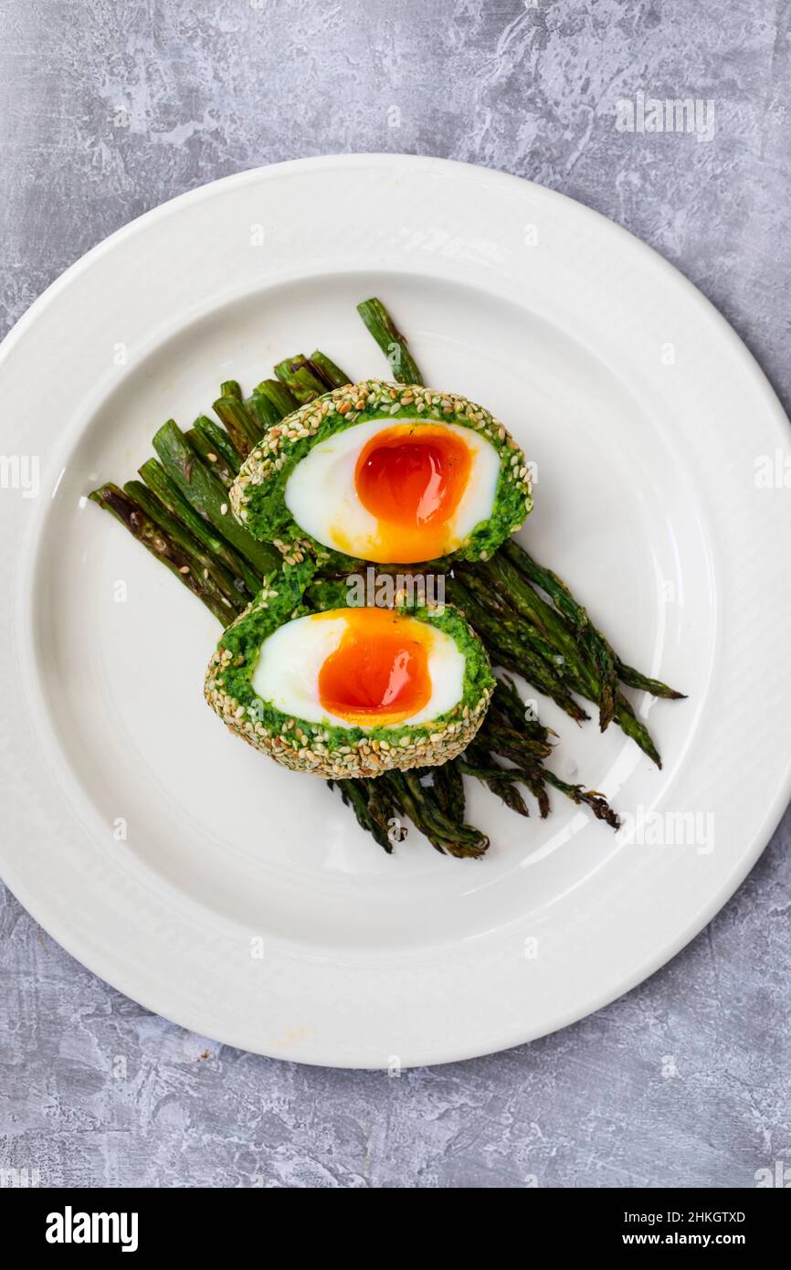 Vegetarian Scotch egg wrapped in pea and broad bean mash Stock Photo