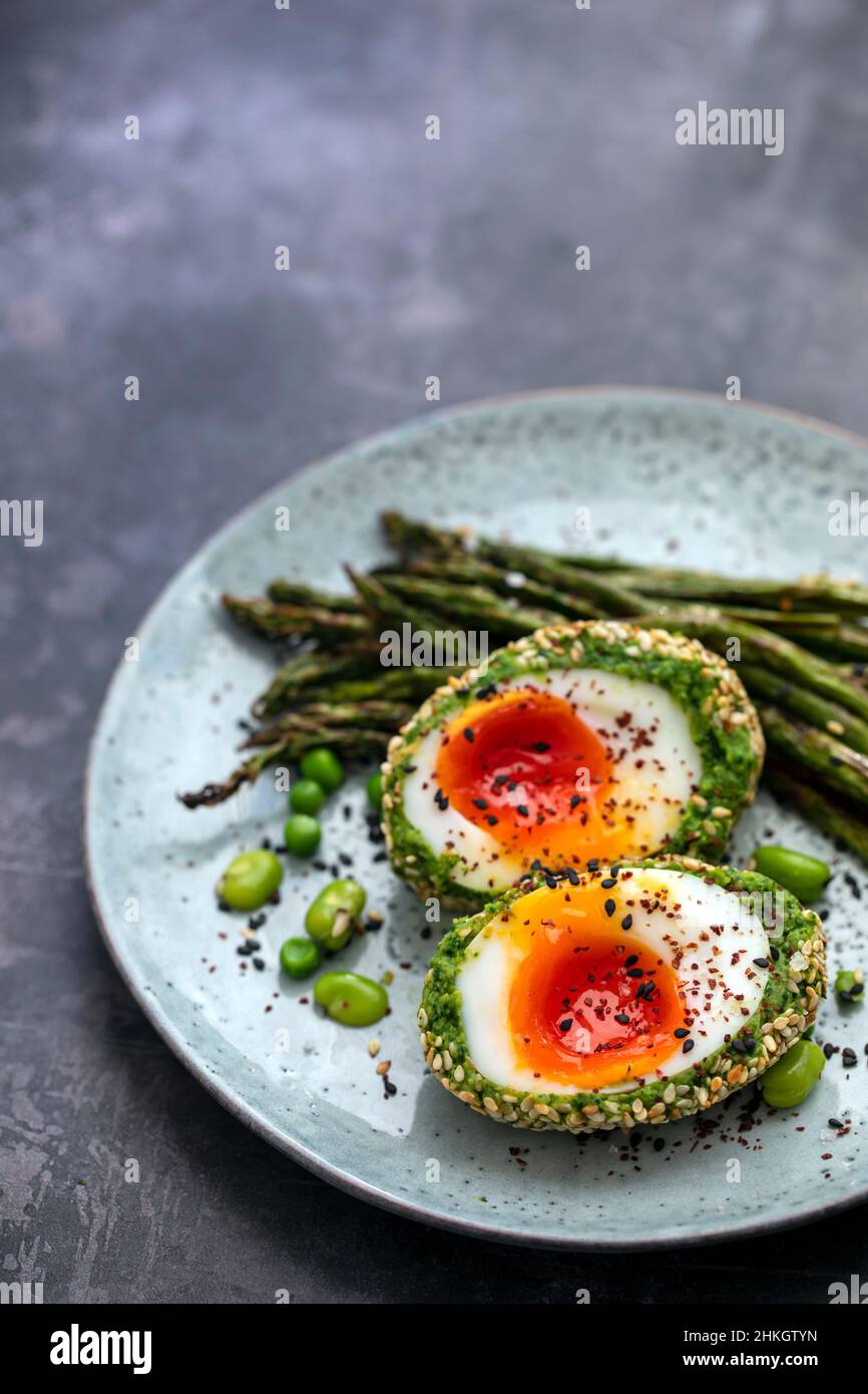 Vegetarian Scotch egg wrapped in pea and broad bean mash Stock Photo