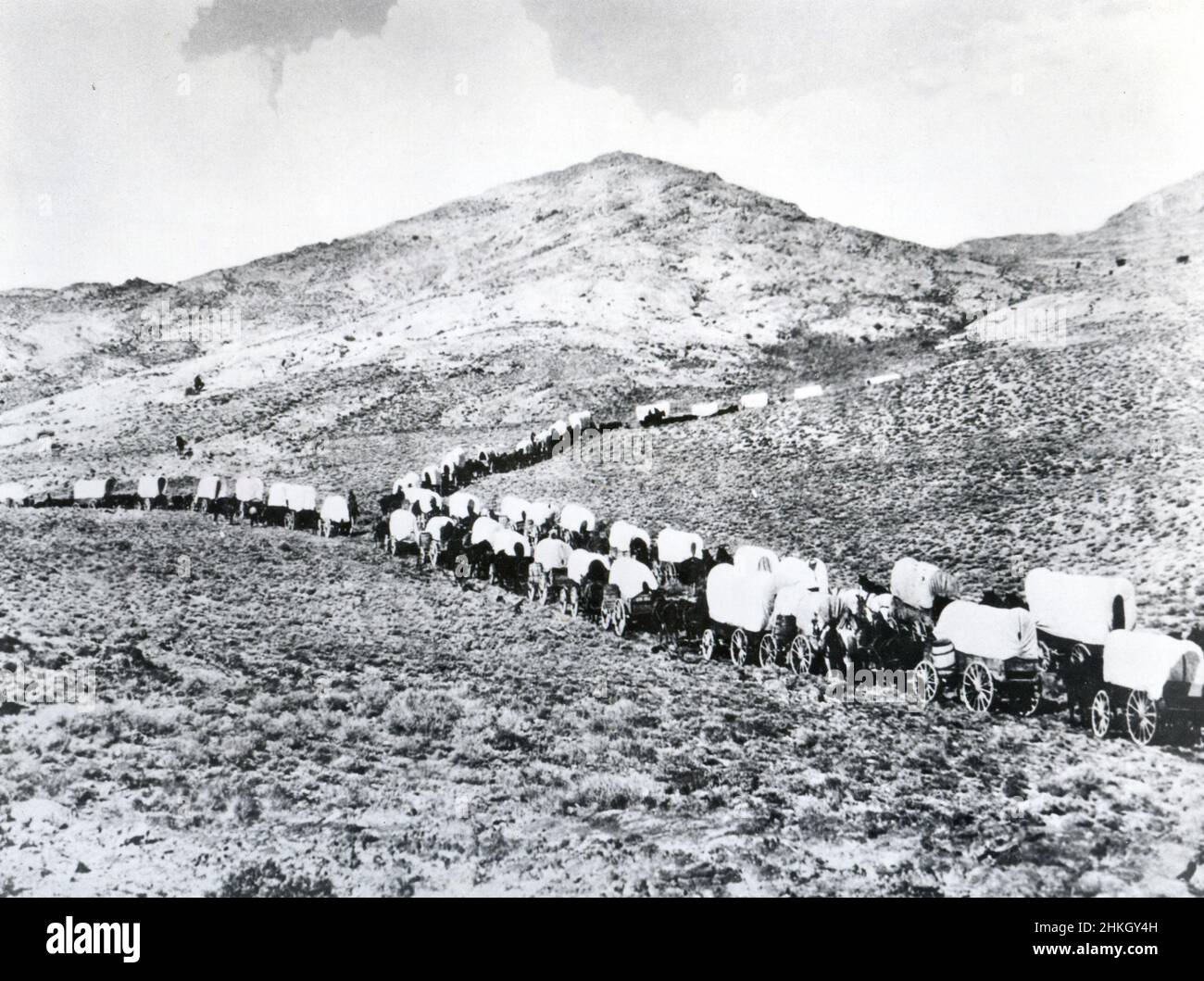 Wending their way through valley and over plains in migration to the West, pioneers formed wagon trains as safeguard against Indians and forces of nature. No date, no location. Stock Photo