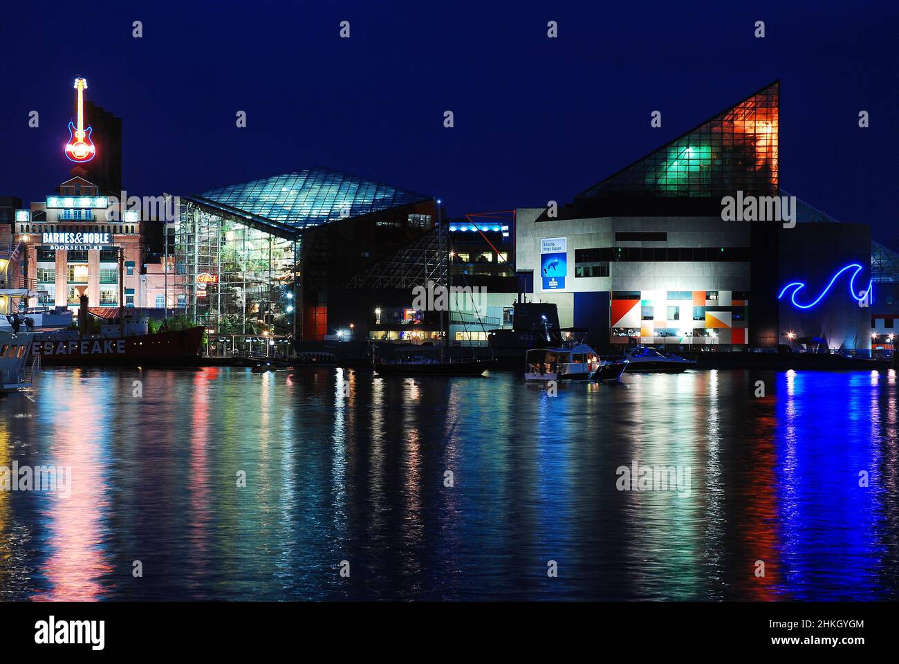 The lights of Baltimore Maryland are reflected in the waters of Inner Harbor Stock Photo