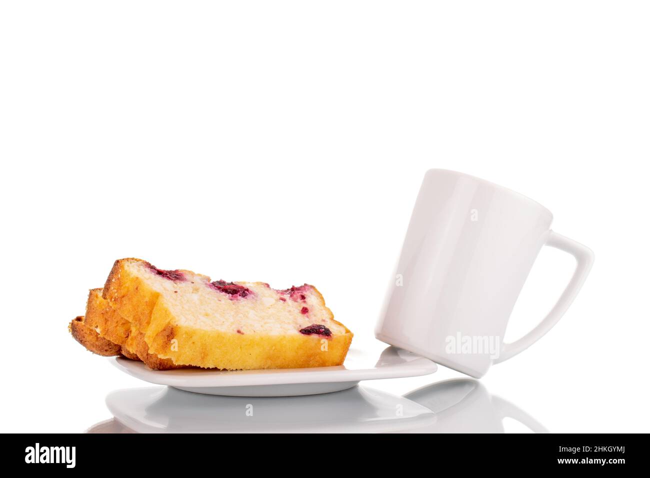 Two slices of homemade cottage cheese casserole with cherries on a white ceramic saucer with a white ceramic cup, macro, isolated on a white backgroun Stock Photo