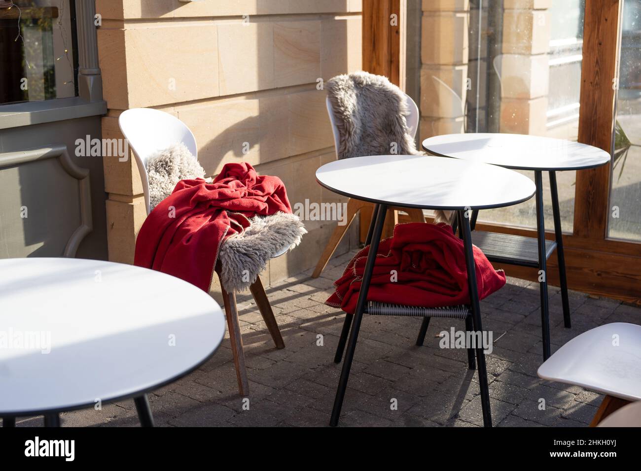 An independent restaurant provides seat covers and blankets to keep customers choosing to sit outdoors warm. Stock Photo
