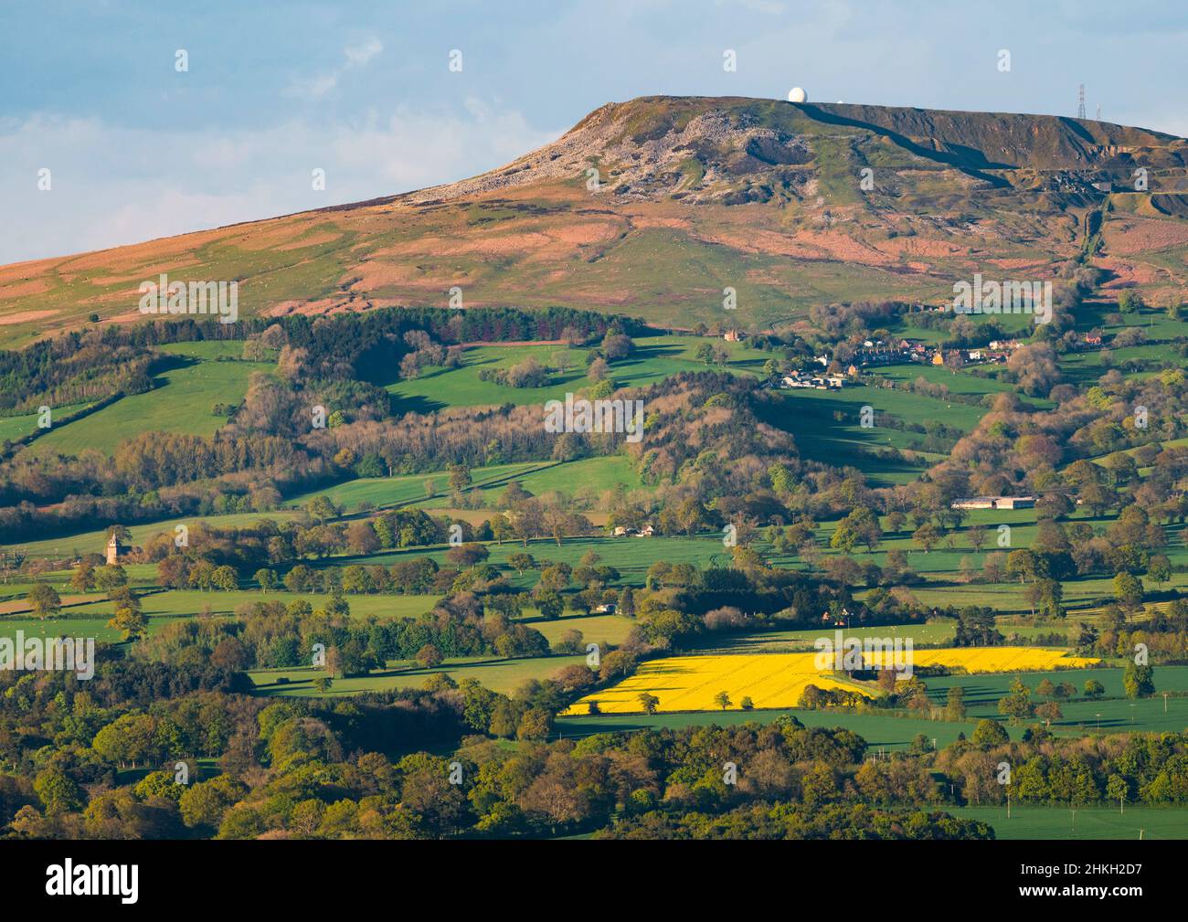 Evening sunlight on Titterstone Clee Hill and the village of Bedlam, Shropshire. Stock Photo