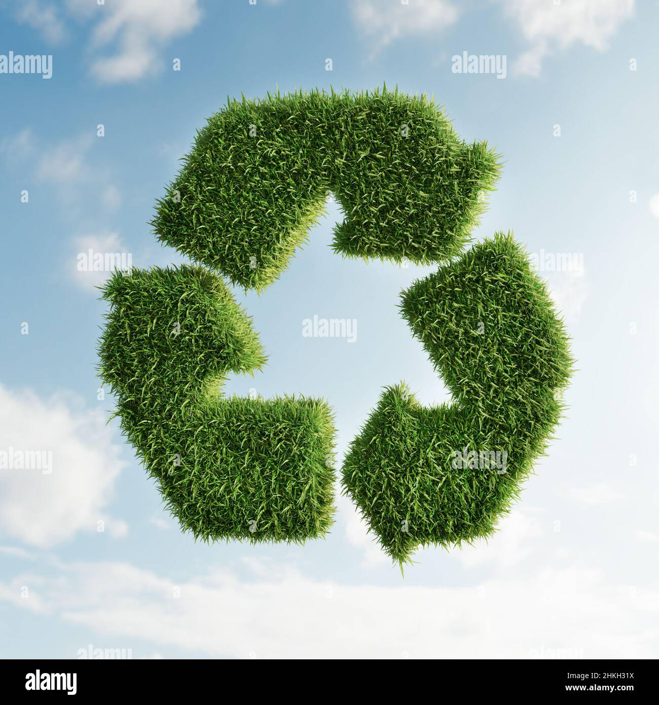 3D rendering of grass covered 3D arrow recycle symbol over sky ...