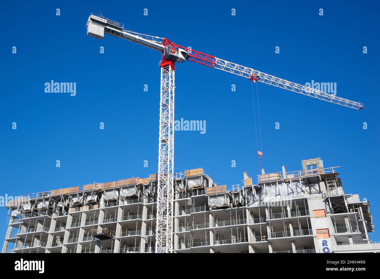 Toronto, Ontario / Canada - 01/28/2022: Crane and building construction activity with blue sky background Stock Photo