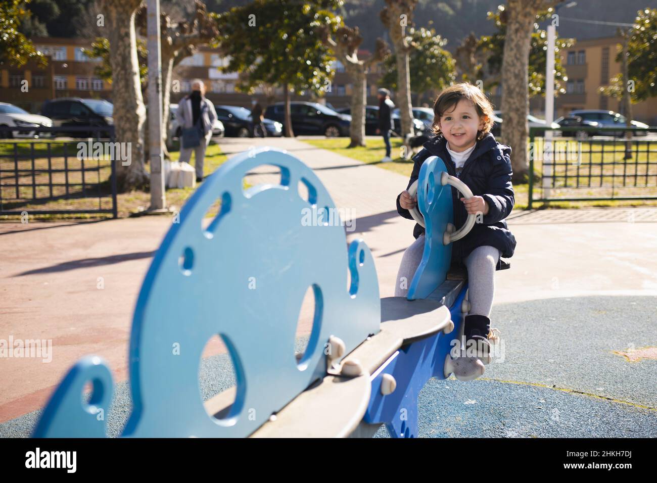 Little girl smiling while playing in the park Stock Photo - Alamy