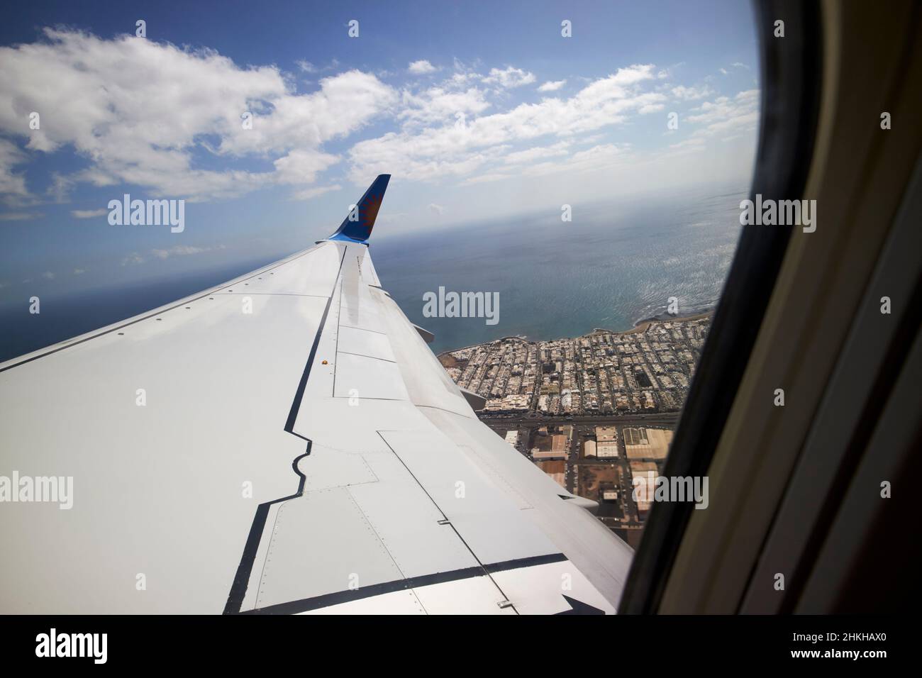 on board aircraft looking out window of plane just taken off from arrecife airport Lanzarote Canary Islands Spain Stock Photo