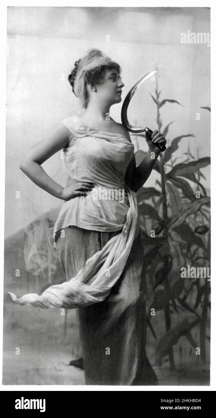 Fitz W Guerin, American photographer - Young Woman holding a Sickle with Corn Stalk in the Background Stock Photo