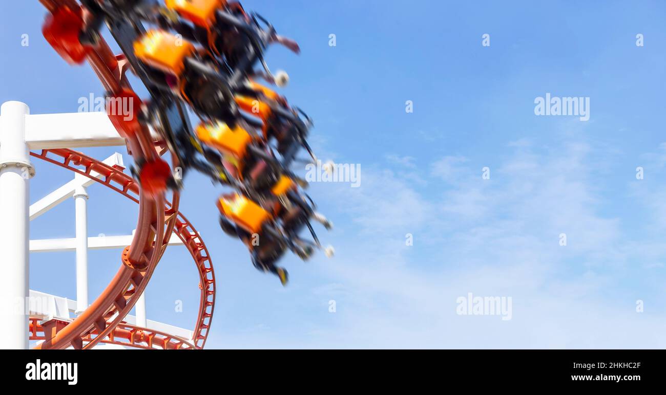 speed move and happy fun holiday of rollercoaster riding on clear summer sky Stock Photo