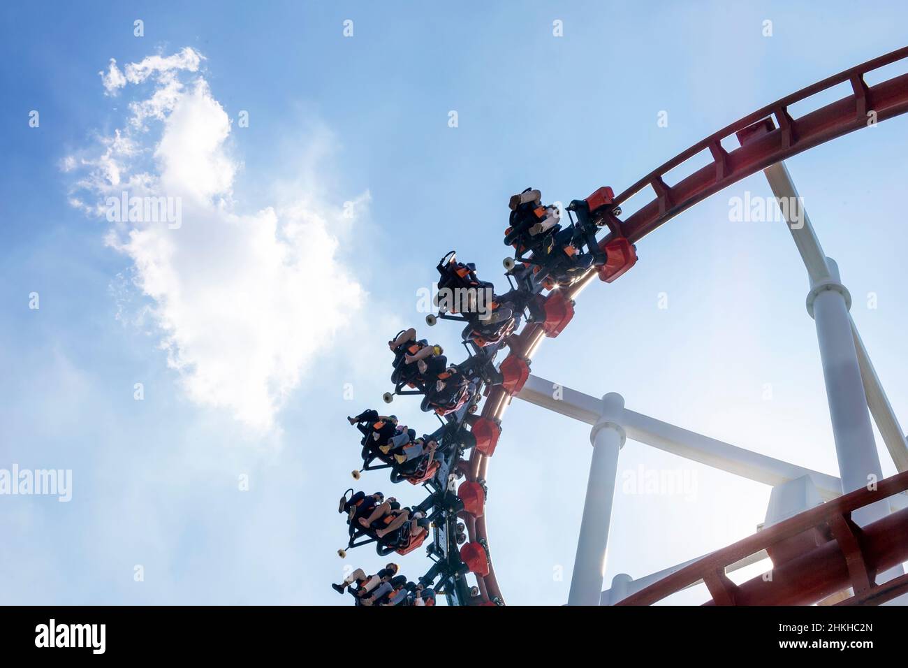 happy fun holiday of rollercoaster with passenger riding on clear summer sky Stock Photo
