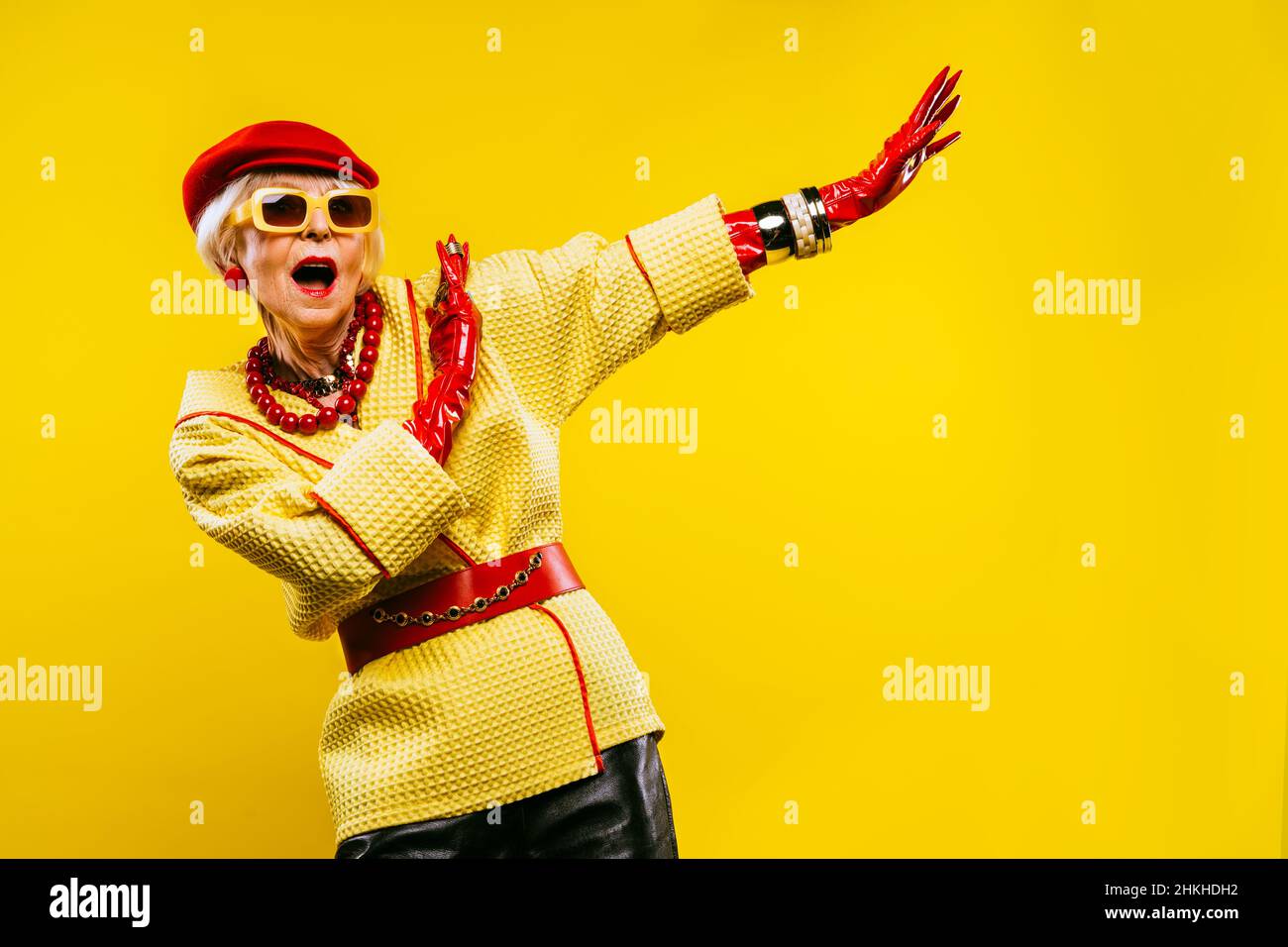 Happy and funny cool old lady with fashionable clothes portrait on ...
