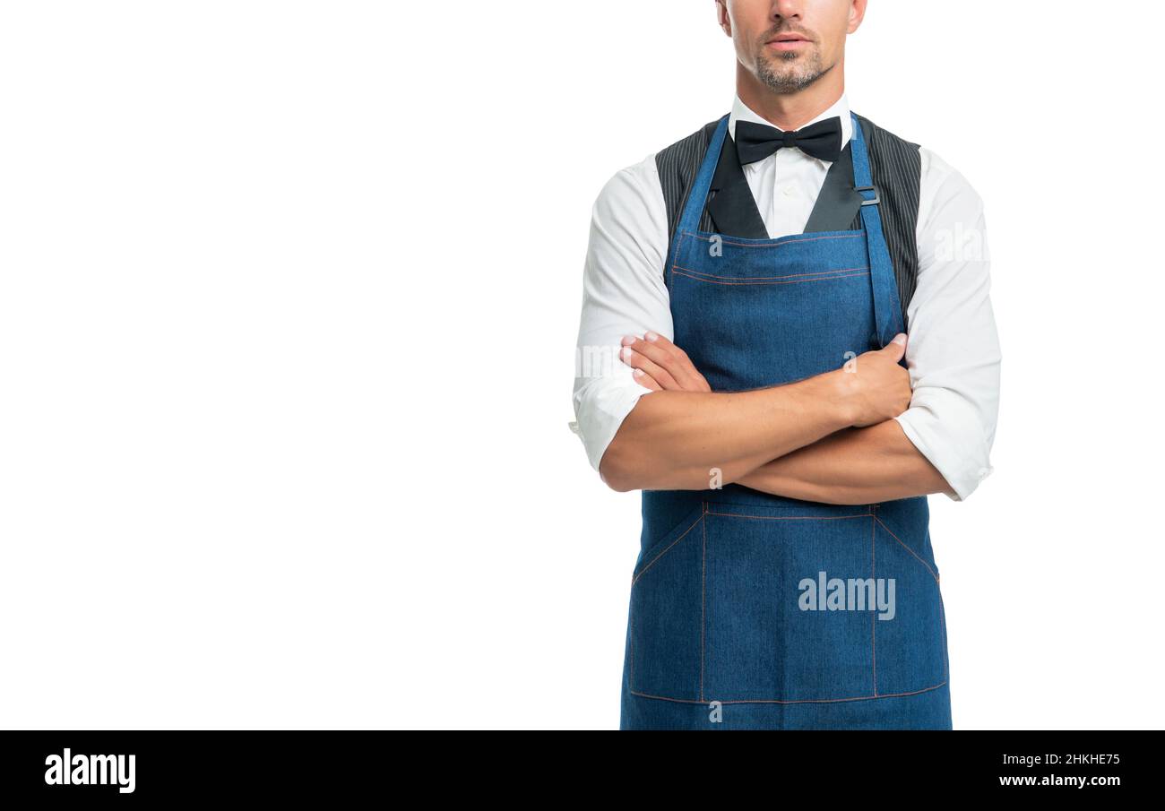 Confident man crop view in bow and bartender apron keeping arms crossed isolated on white, copy space Stock Photo