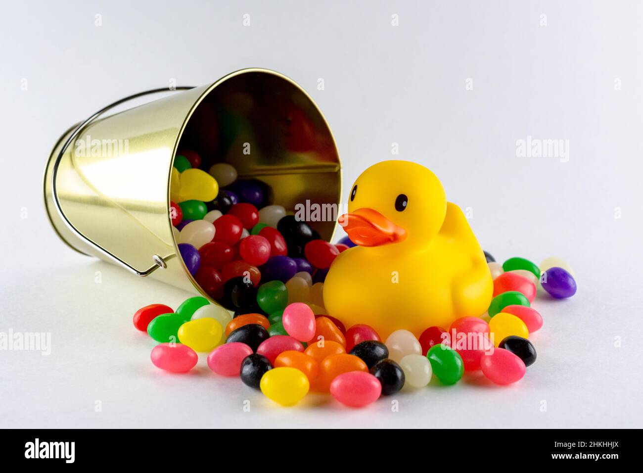 A rubber duck surrounded by assorted jelly beans from spilled pail