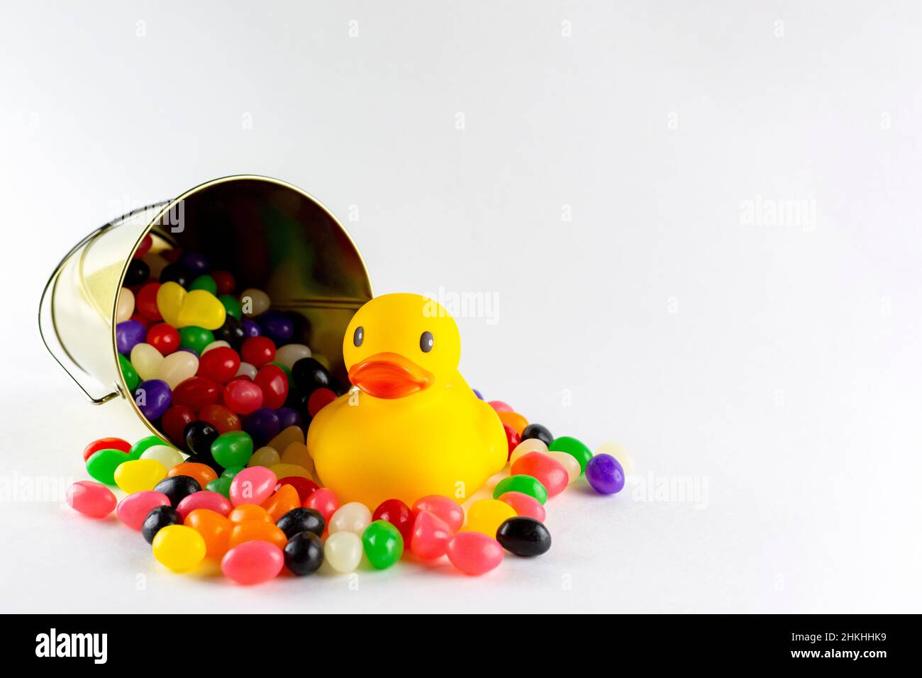 A rubber duck surrounded by assorted jelly beans from spilled pail
