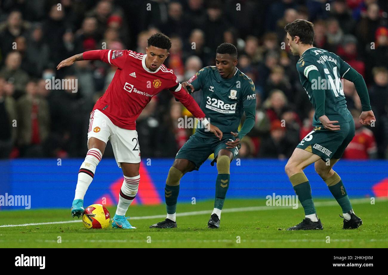 Manchester United's Jadon Sancho (left) battles with Middlesbrough's Isaiah Jones (centre) and Jonny Howson during the Emirates FA Cup fourth round match at Old Trafford, Manchester. Picture date: Friday February 4, 2022. Stock Photo
