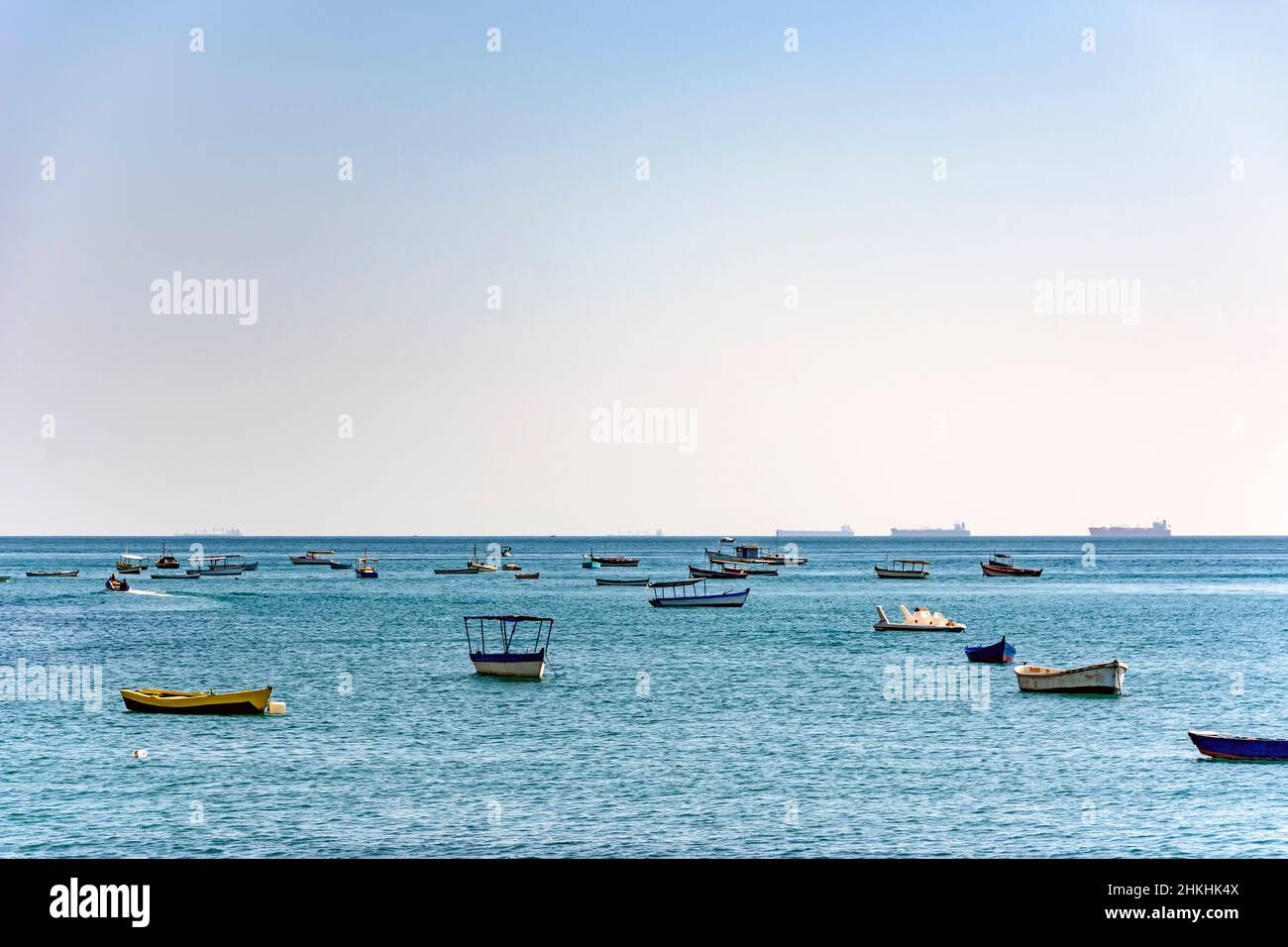 Evening at Todos os Santos bay in Salvador Bahia during a sunny summer day with its moored boats and the skyline Stock Photo