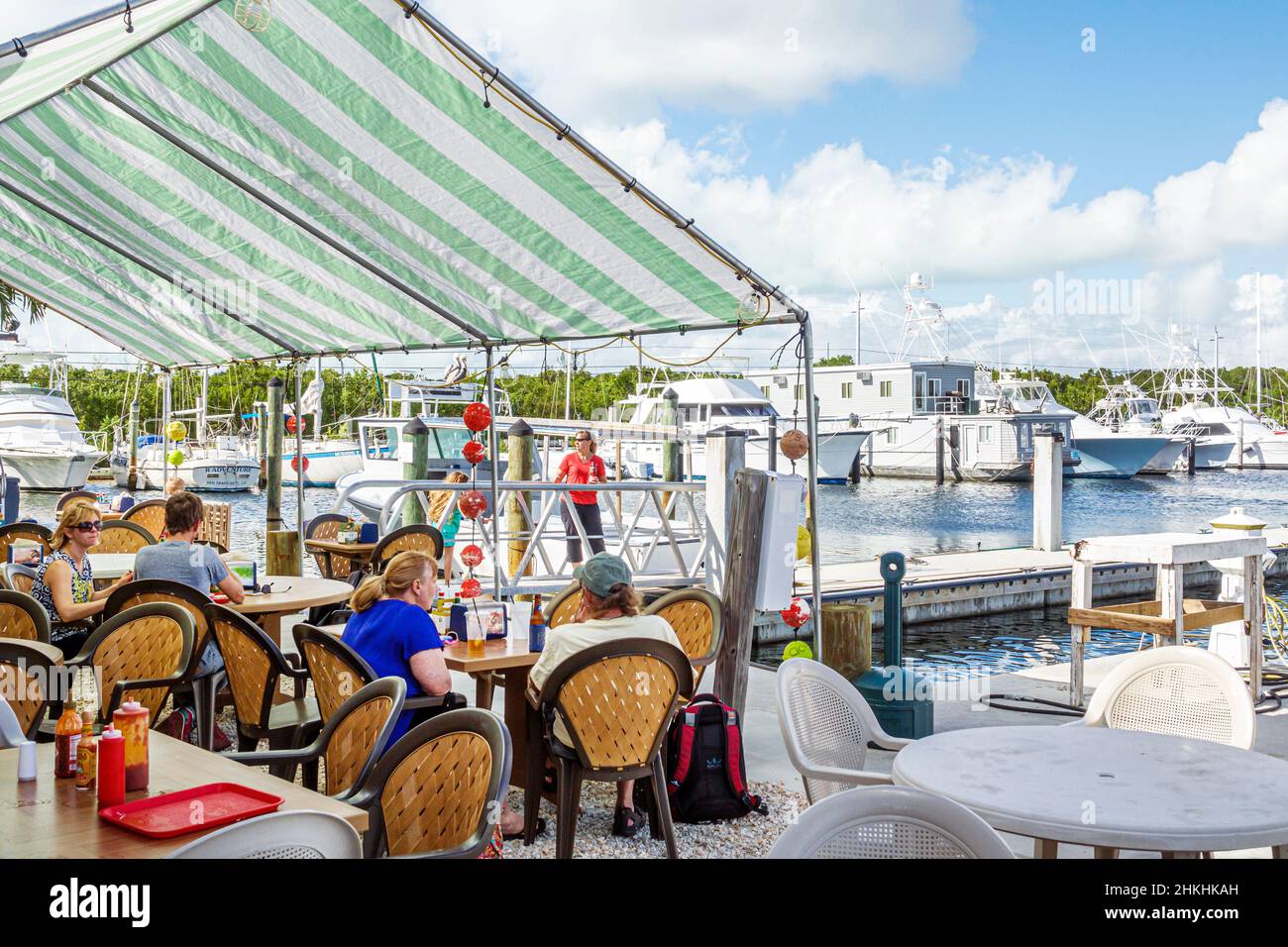 Florida Upper Keys,Key Largo Fisheries Backyard,restaurant waterfront,dining al fresco outside tables marina boats Stock Photo