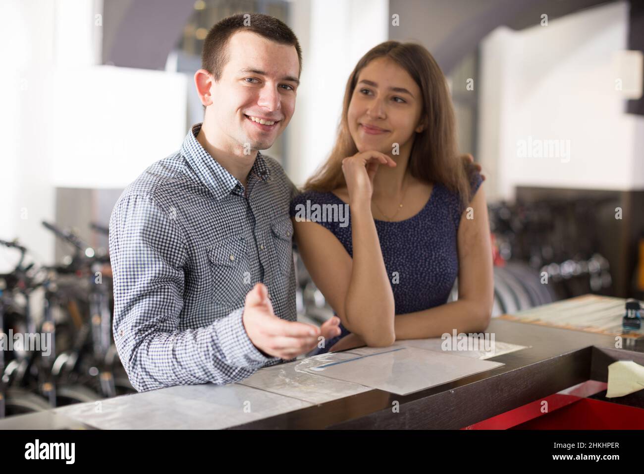 girl with guy hire bikes in the rental salon Stock Photo
