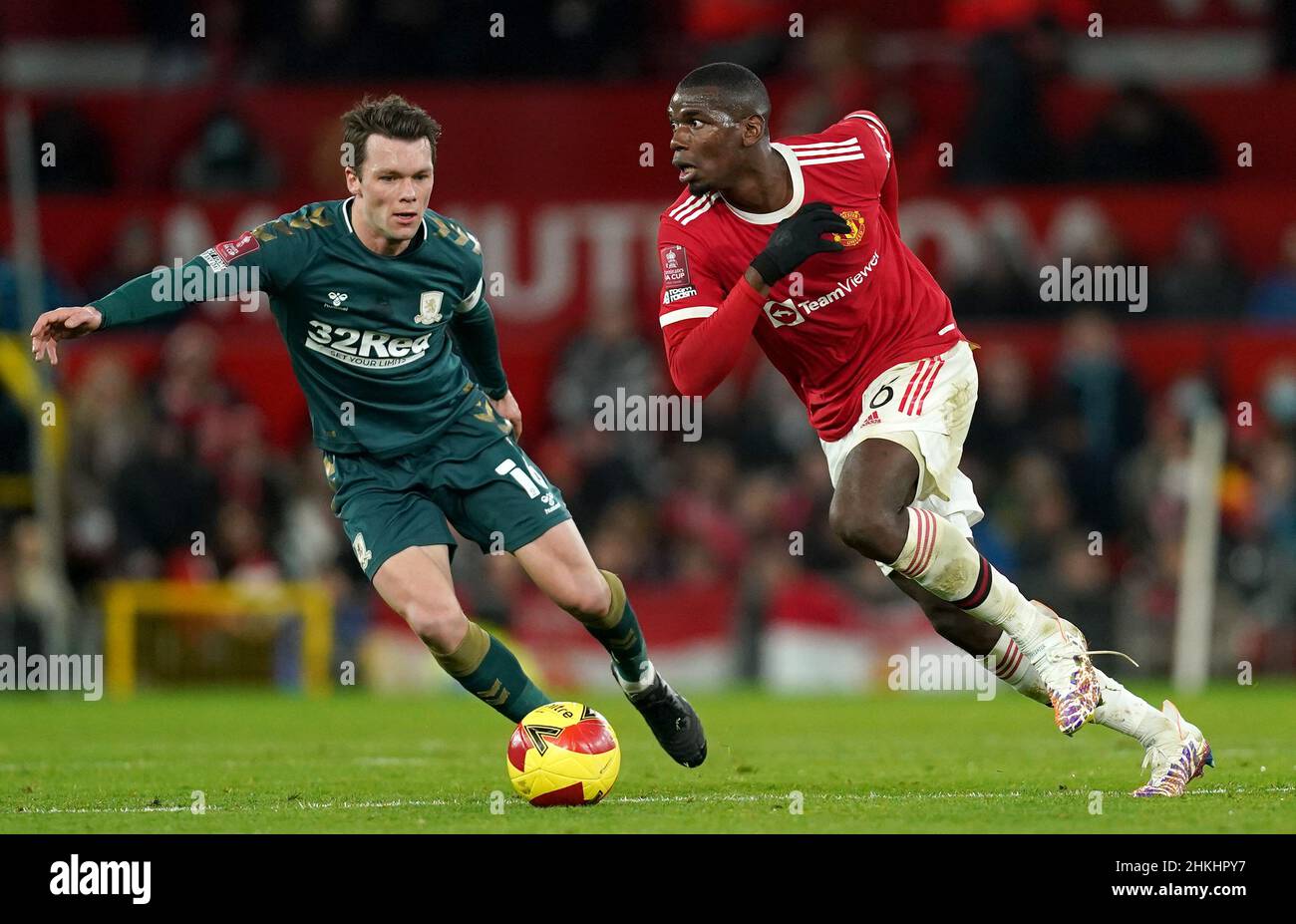 Middlesbrough's Jonny Howson (left) and Manchester United's Paul Pogba battle for the ball during the Emirates FA Cup fourth round match at Old Trafford, Manchester. Picture date: Friday February 4, 2022. Stock Photo