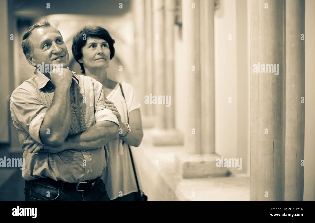 mature pensioner family visiting historical exhibition in Museum Stock Photo