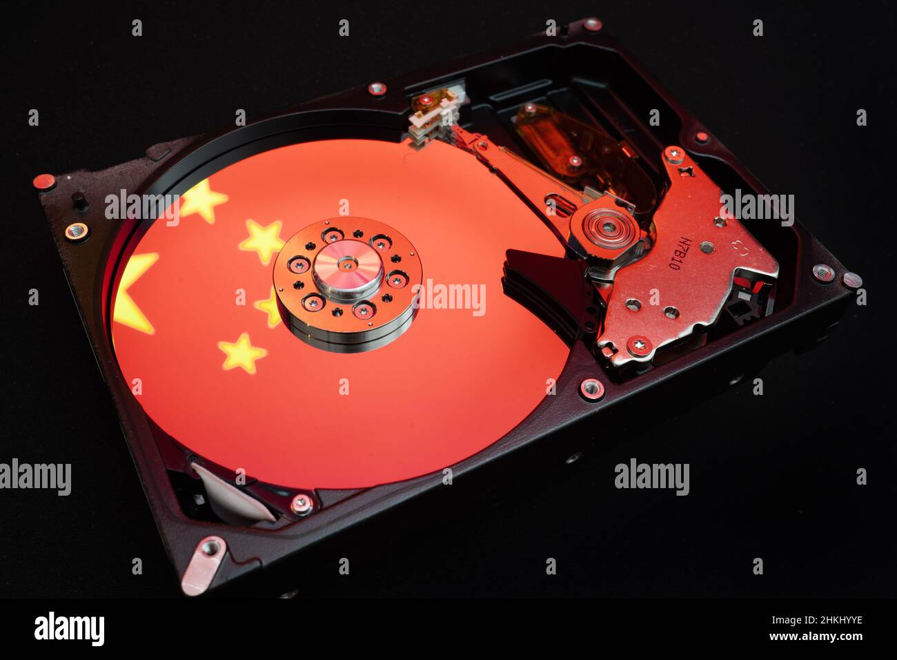 Chinese flag reflected on a disassembled HDD Stock Photo