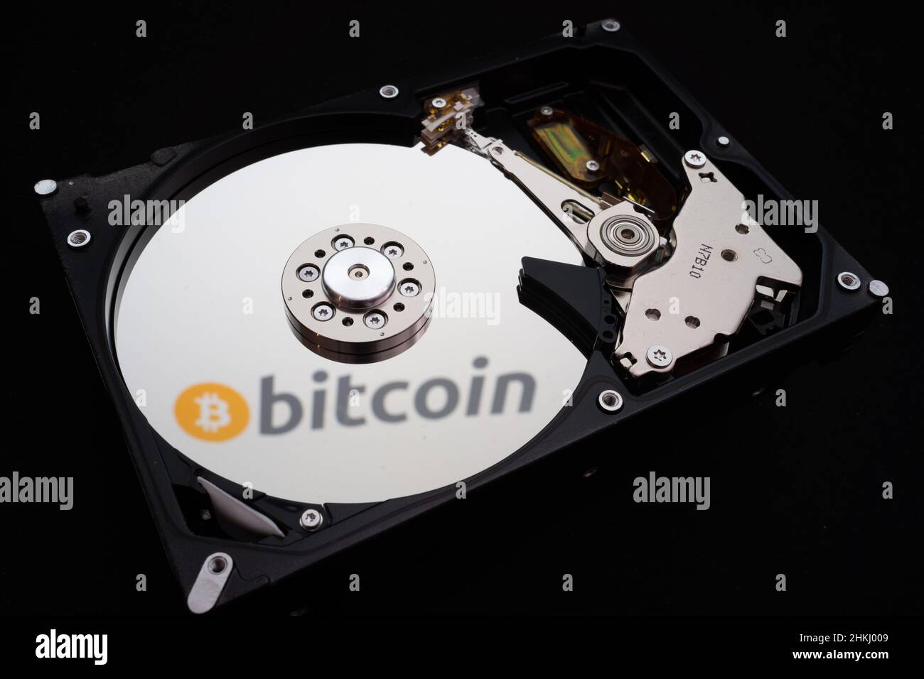 Bitcoin logo reflected on a disassembled HDD Stock Photo - Alamy