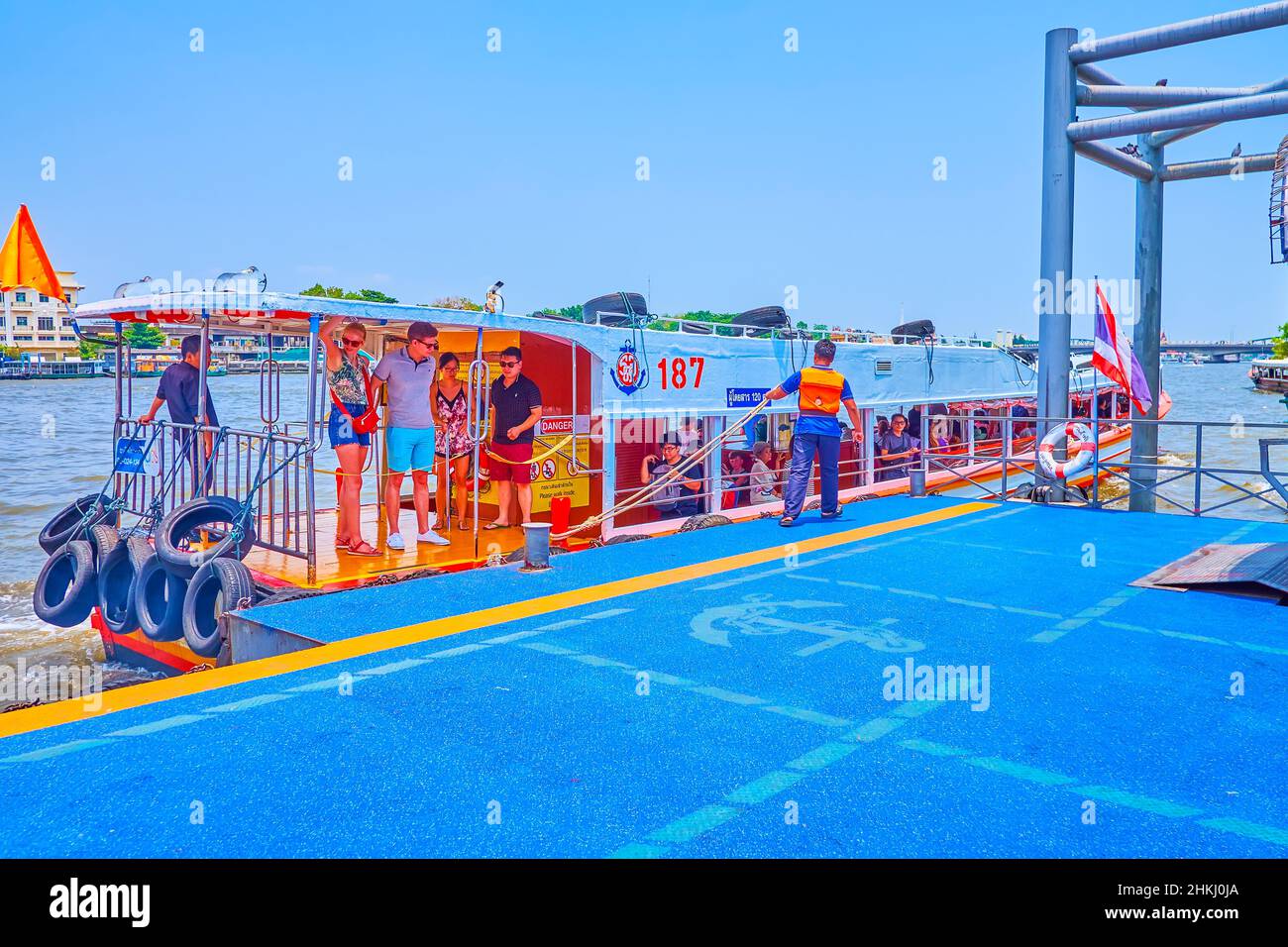 BANGKOK, THAILAND - MAY 12, 2019: Arriving of the passenger ferry on Chao Phraya River with embarkation of passengers to the pontoon pier, on May 12 i Stock Photo