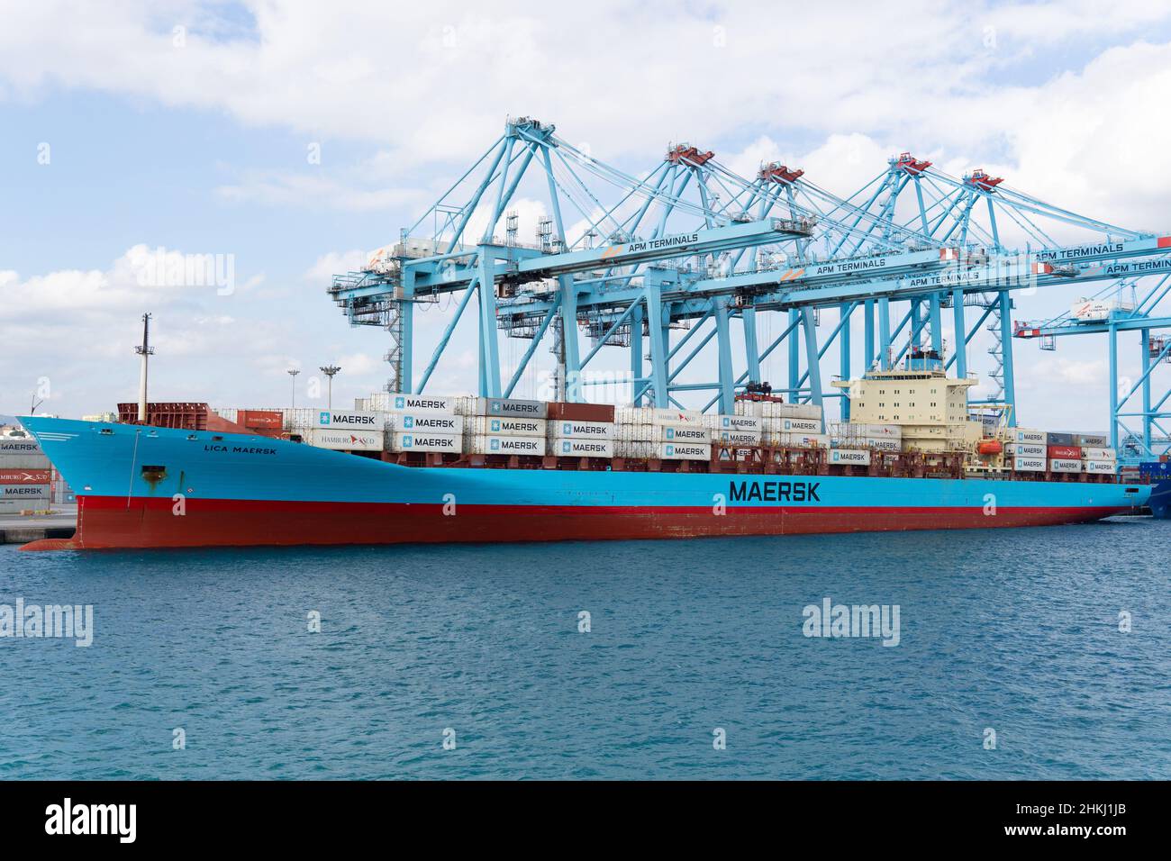A Maersk Line freighter is docked on harbor, Container ship at industrial port in import export busi Stock Photo