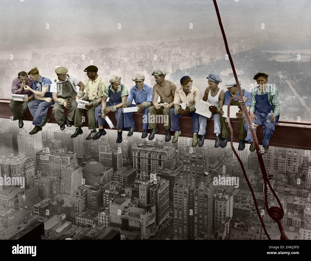 Lunch atop a Skyscraper, New York, 1932. Old Photograph hand-colouring. Workers eat sitting on an iron beam. Color image view from Black and white. Stock Photo