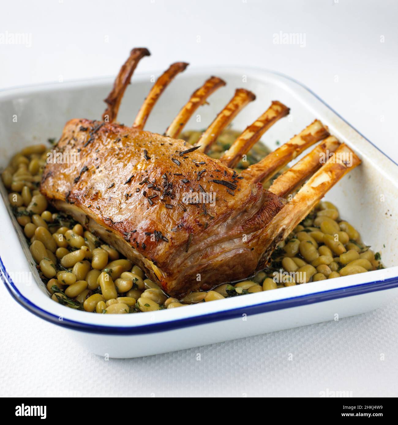 Roast rack of lamb with flageolet beans and herbs Stock Photo Alamy