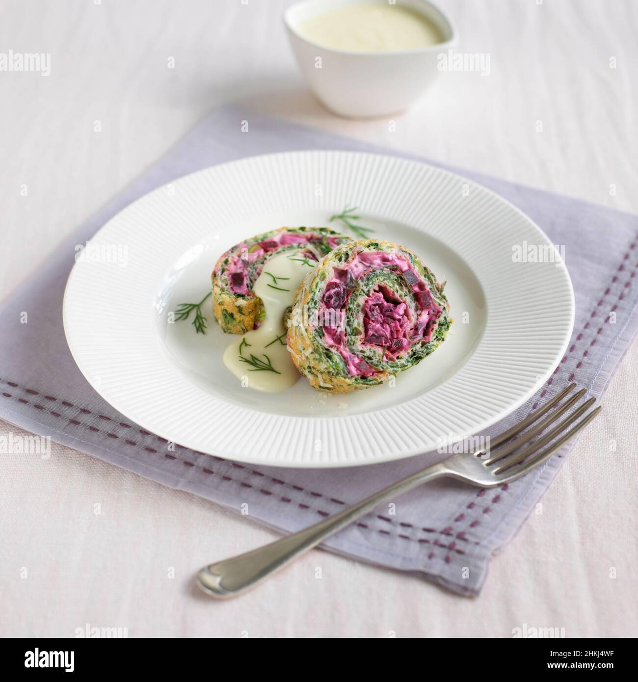 Watercress and beetroot roulade with cheese sauce Stock Photo - Alamy