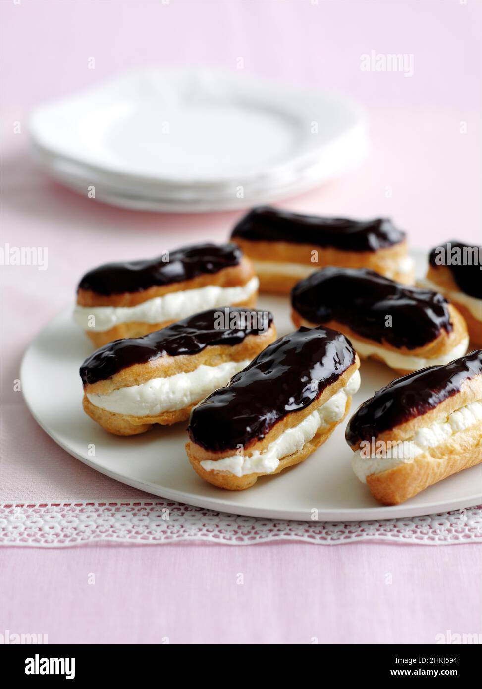 Eclairs with chocolate icing and whipped cream filling Stock Photo - Alamy