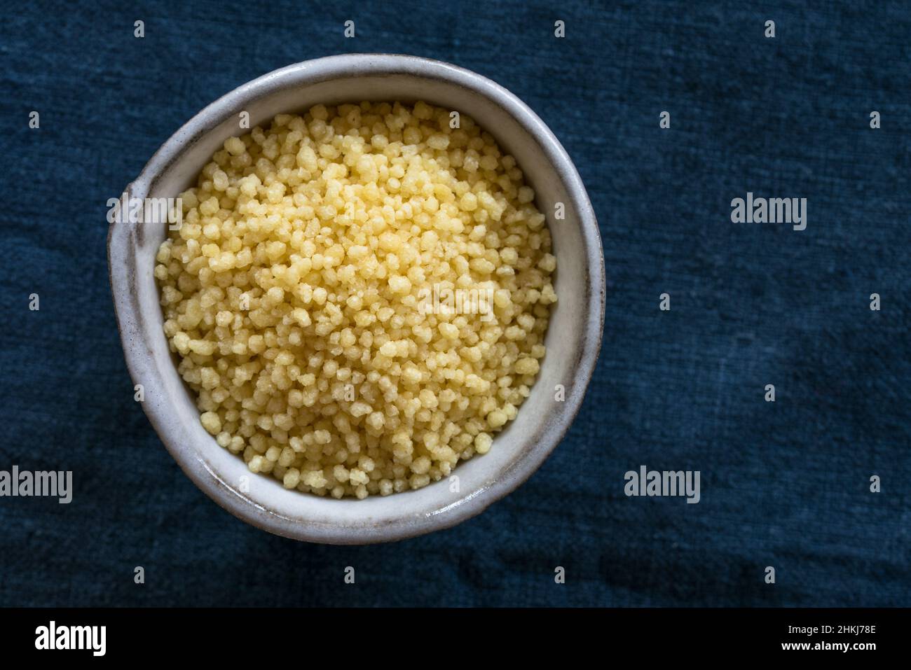 Uncooked Couscous in a Bowl Stock Photo