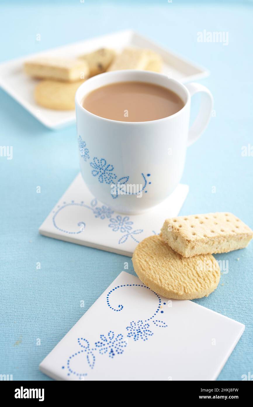 Cup of milky tea, butter biscuits and shortbread Stock Photo