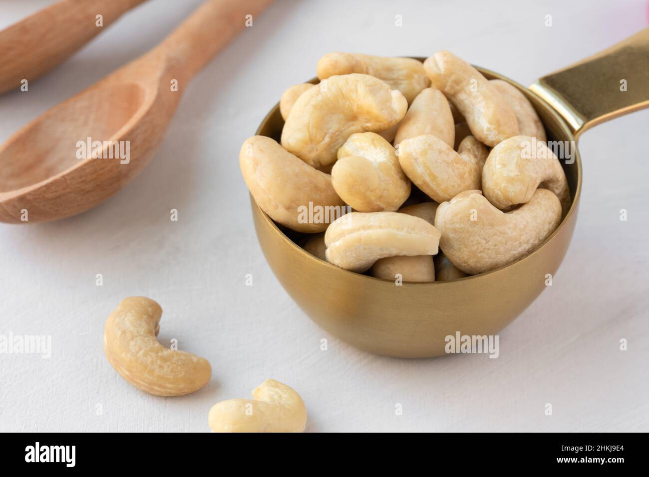 Raw Cashews in a Measuring Cup Stock Photo