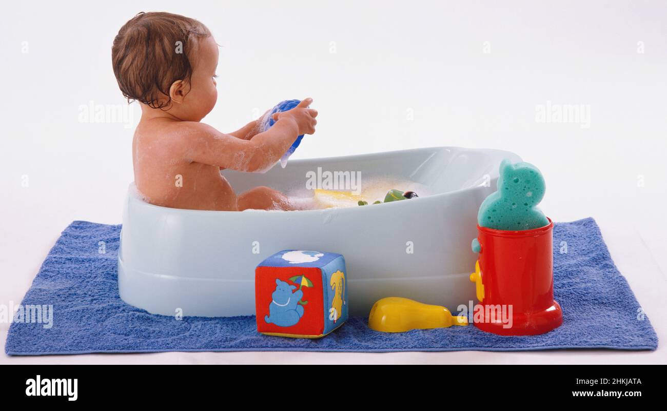 Baby having bubble bath in child's bathtub Stock Photo Alamy
