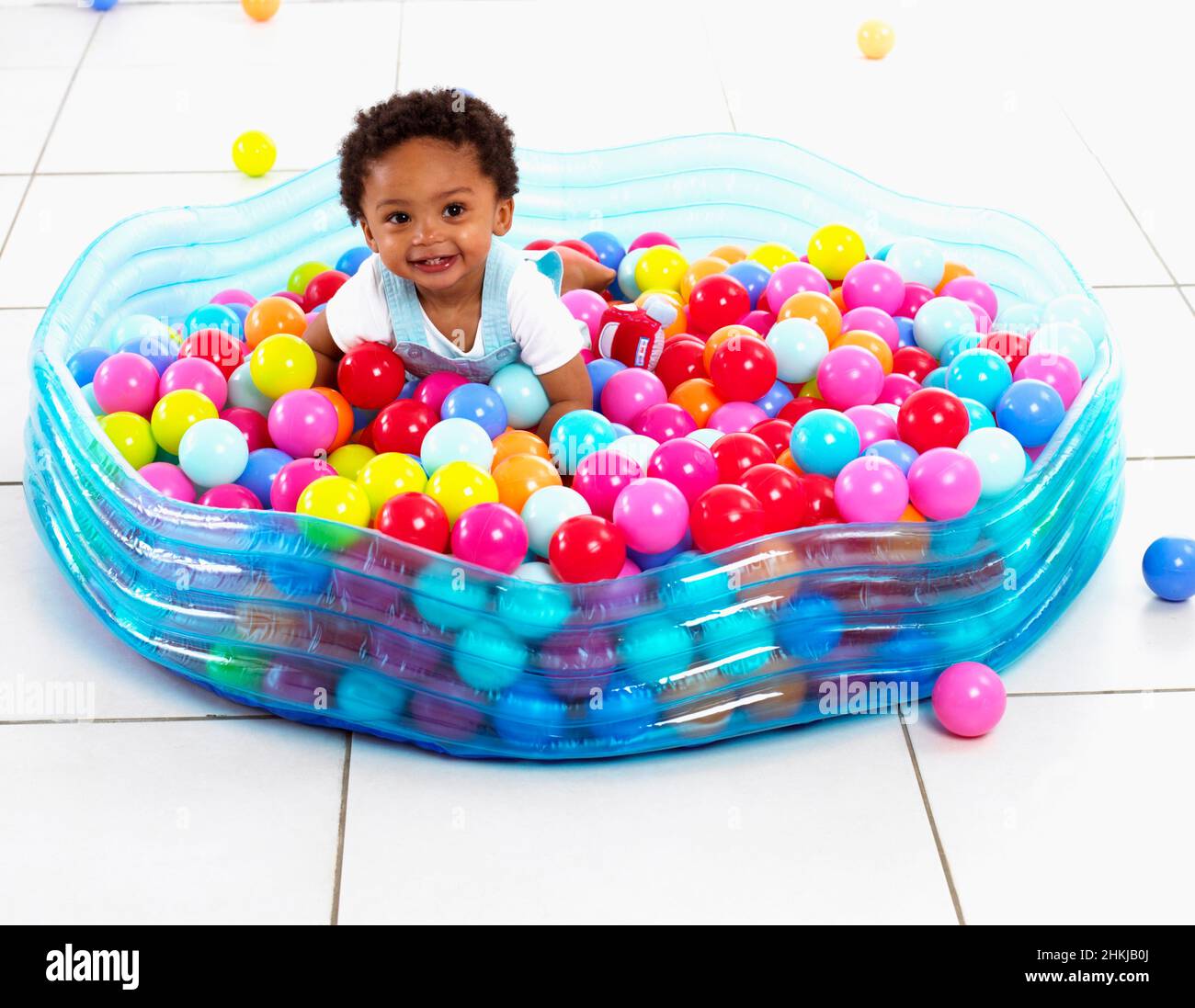 Boy playing in paddling pool filled with plastic balls Stock Photo Alamy
