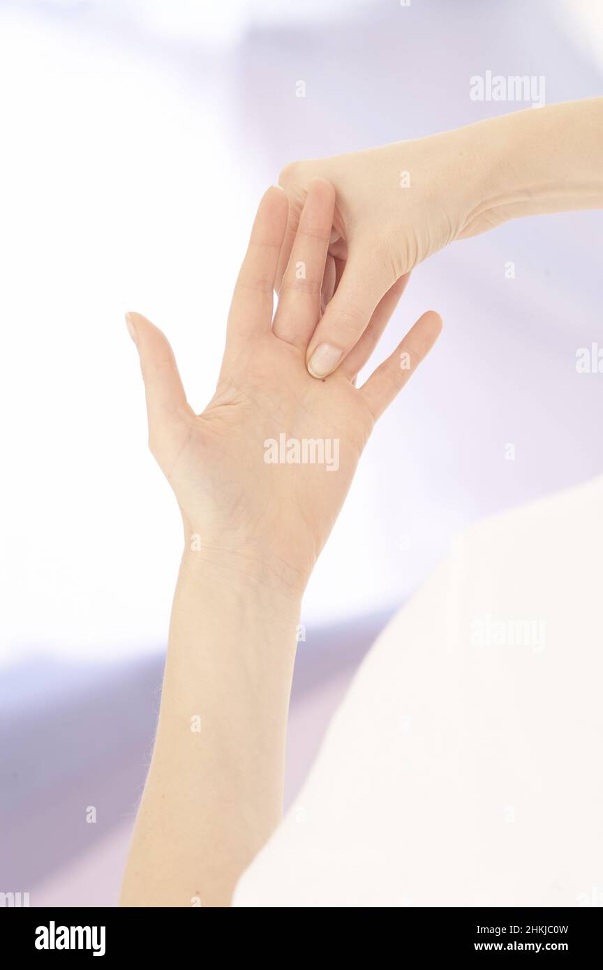 Pinching webbing between thumb and index finger Stock Photo Alamy