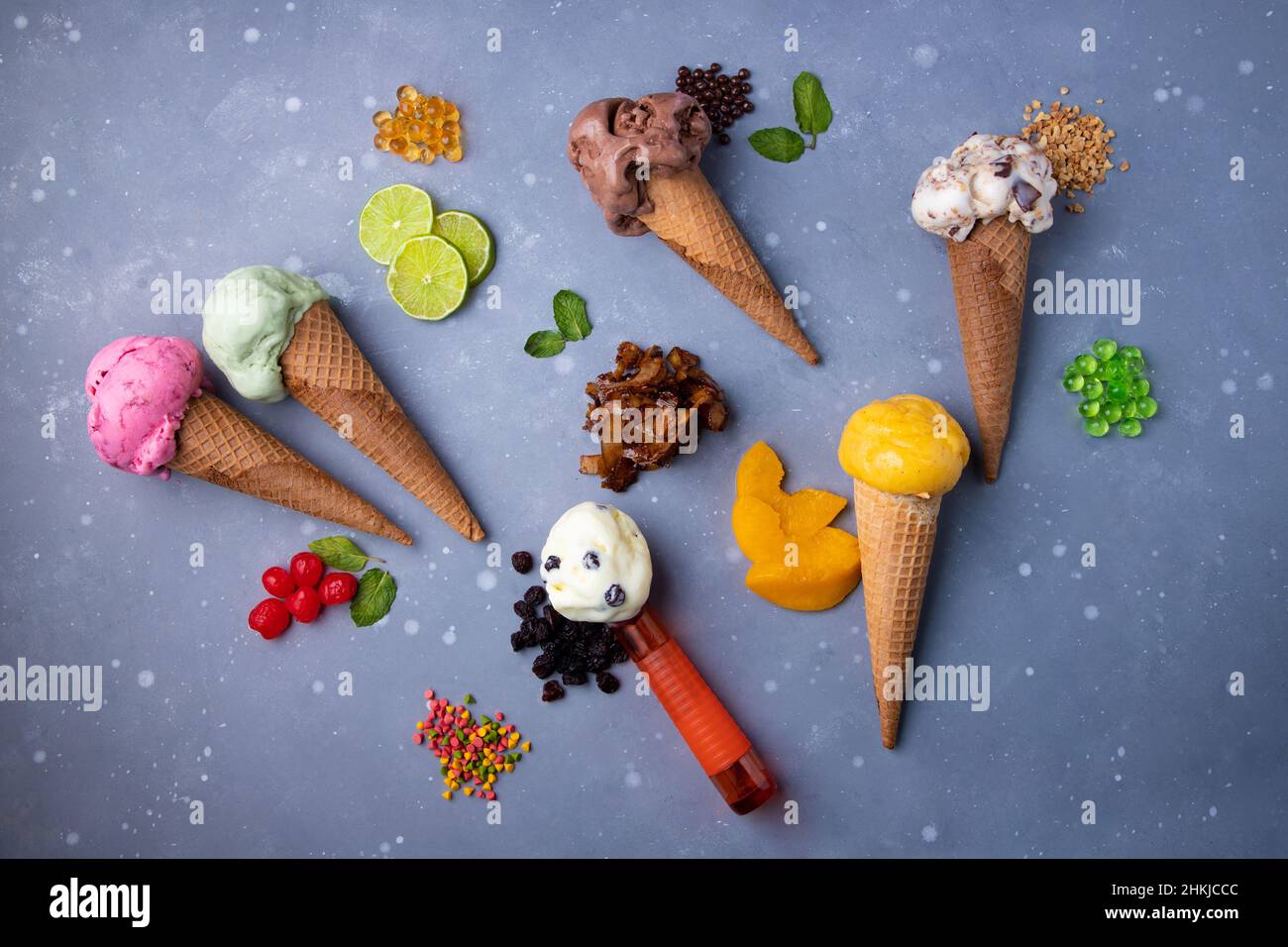Top view of ice cream of different flavors in waffle cones with candies ...