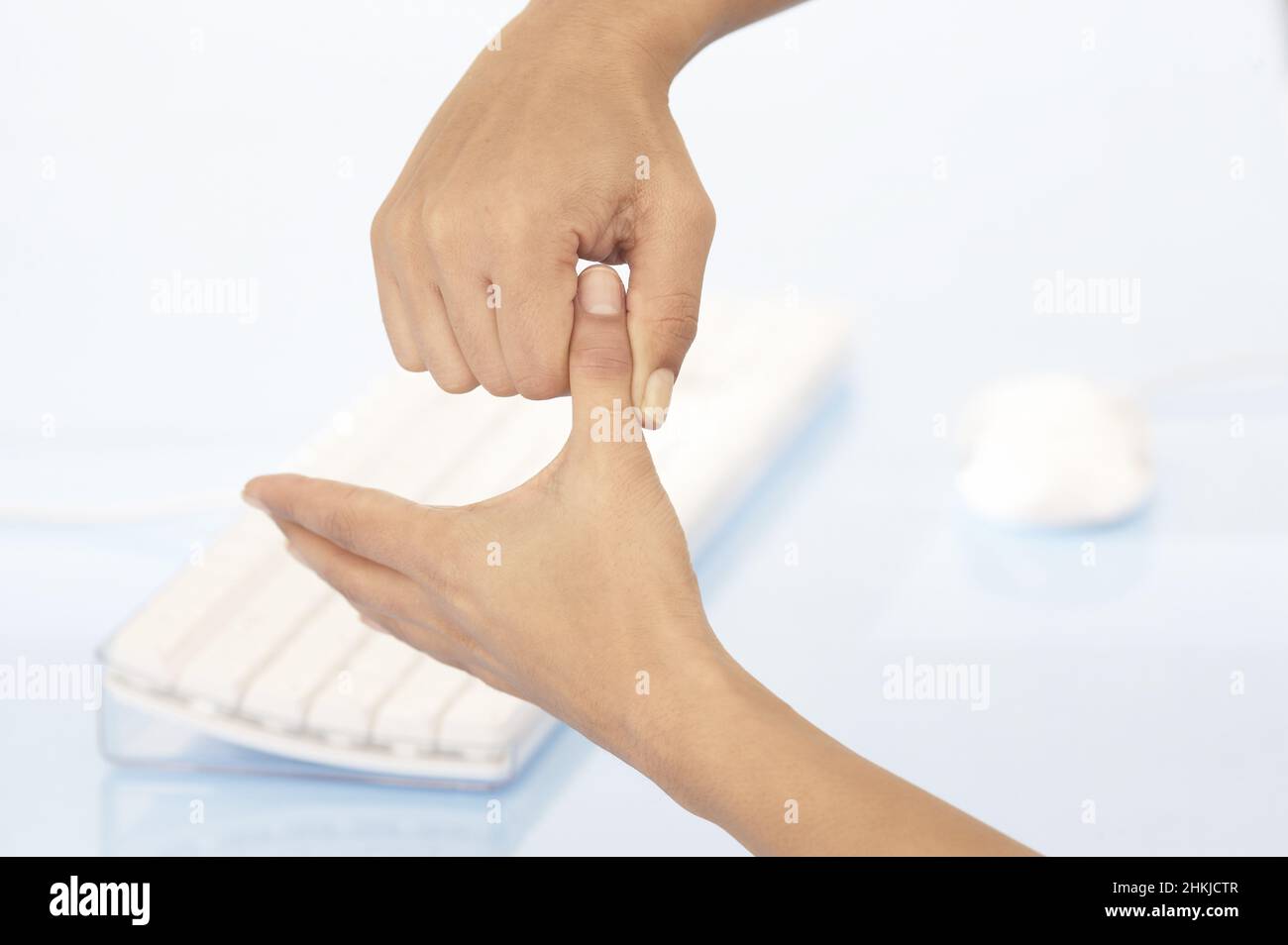 Applying side-to-side technique to thumb to relax neck Stock Photo - Alamy